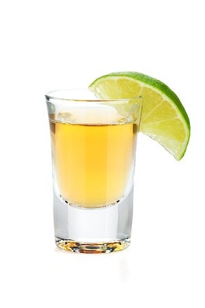 Shot of gold tequila with lime slice. Isolated on white background Stock Photo - Budget Royalty-Free & Subscription, Code: 400-07166614