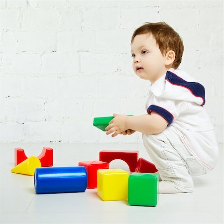 beautiful little boy playing with colorful cubes Stock Photo - Budget Royalty-Free & Subscription, Code: 400-07167058