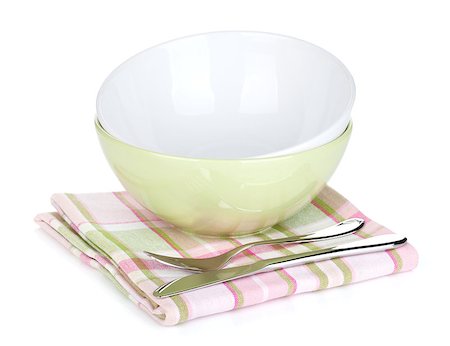 simsearch:689-03128420,k - Salad bowl and silverware over kitchen towel. Isolated on white background Fotografie stock - Microstock e Abbonamento, Codice: 400-07167135