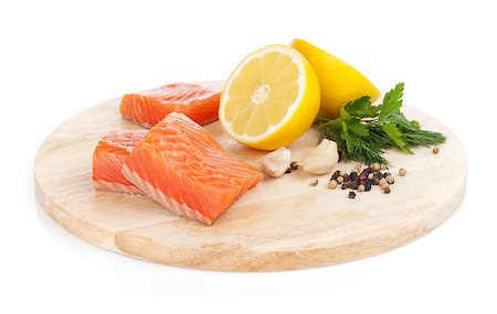 simsearch:400-08187570,k - Salmon steaks on cutting board with lemons and herbs. Isolated on white background Stockbilder - Microstock & Abonnement, Bildnummer: 400-07167145