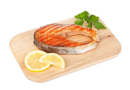 simsearch:400-05381790,k - Grilled salmon with lemon and herbs on cutting board. Isolated on white background Foto de stock - Super Valor sin royalties y Suscripción, Código: 400-07167149