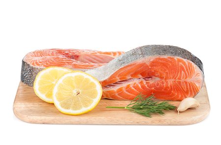 simsearch:400-08187570,k - Salmon steaks on cutting board with lemons and herbs. Isolated on white background Stockbilder - Microstock & Abonnement, Bildnummer: 400-07167140