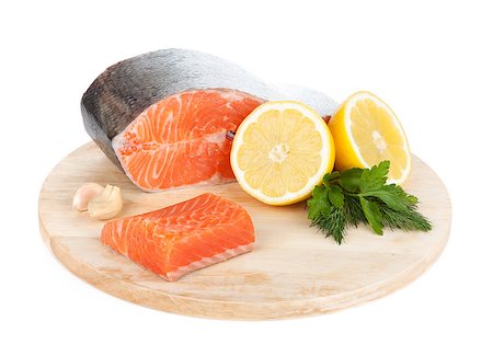 simsearch:400-08187570,k - Salmon on cutting board with lemons and herbs. Isolated on white background Stockbilder - Microstock & Abonnement, Bildnummer: 400-07167141