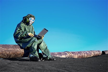 A scientist working with a laptop on a chemically contaminated area Stock Photo - Budget Royalty-Free & Subscription, Code: 400-07167152