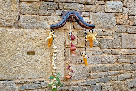 Traditional Dalmatian ornament on stone wall - corn, onion, garlic, horse collar Stock Photo - Budget Royalty-Free & Subscription, Code: 400-07167182