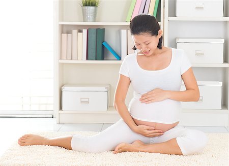 Asian 8 months pregnant woman sitting on floor at home. Pregnancy relaxation. Stock Photo - Budget Royalty-Free & Subscription, Code: 400-07167252