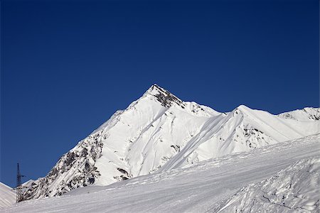 simsearch:400-07217910,k - Ski slope and blue clear sky at sunny day. Caucasus Mountains, Georgia, ski resort Gudauri. Stock Photo - Budget Royalty-Free & Subscription, Code: 400-07167405