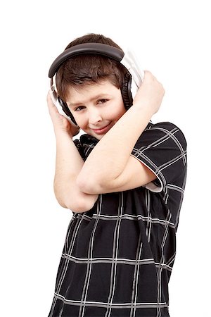 Portrait of a happy smiling young boy listening to music on headphones against white background Stock Photo - Budget Royalty-Free & Subscription, Code: 400-07167693