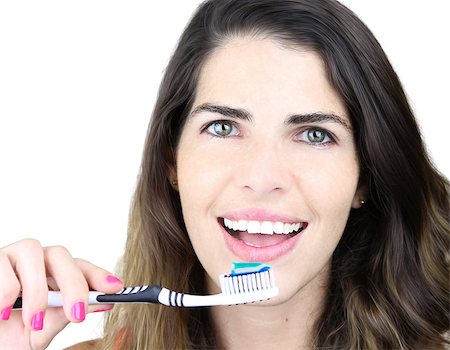 Smiling young woman with healthy teeth holding a toothbrush Stock Photo - Budget Royalty-Free & Subscription, Code: 400-07167790