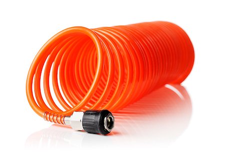 simsearch:400-07167932,k - Orange red thin spiral air hose used for pneumatic tools. Isolated on white with natural reflection. Very short depth-of field, the sharpness is in the connector. Foto de stock - Super Valor sin royalties y Suscripción, Código: 400-07167922