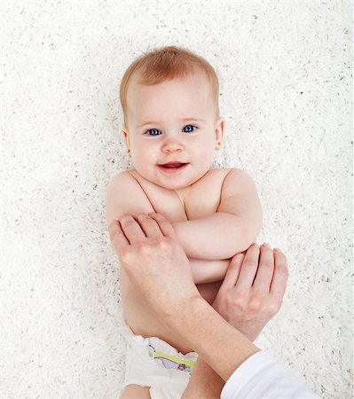 Baby exercise - mother hands playing with young child Fotografie stock - Microstock e Abbonamento, Codice: 400-07168847