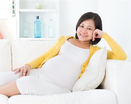 Portrait of an attractive pregnant Asian Chinese woman resting on sofa at home Stock Photo - Budget Royalty-Free & Subscription, Code: 400-07168917