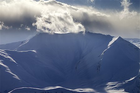 simsearch:400-07211845,k - Mountains in sunset with sunlit clouds. Caucasus Mountains, Georgia, view from ski resort Gudauri. Stockbilder - Microstock & Abonnement, Bildnummer: 400-07169012