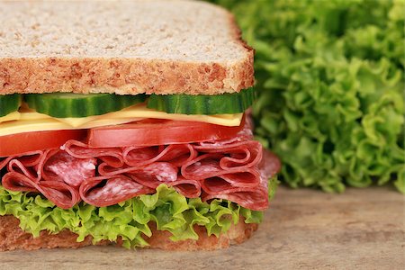 simsearch:400-04416282,k - Salami sandwich served with cheese, tomatoes, lettuce and cucumber Stock Photo - Budget Royalty-Free & Subscription, Code: 400-07169099