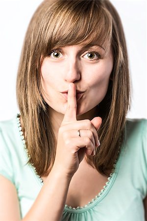 simsearch:400-04238180,k - Young woman with finger on her mouth to indicate that you should be quiet Stockbilder - Microstock & Abonnement, Bildnummer: 400-07169264