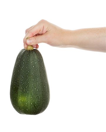 simsearch:400-07224405,k - Hand holding organic green zucchini isolated on white Photographie de stock - Aubaine LD & Abonnement, Code: 400-07169795