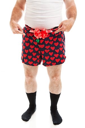 Humorous photo of a guy in boxer shorts with a bow, offering his crotch as a Christmas gift.  Isolated on white. Stock Photo - Budget Royalty-Free & Subscription, Code: 400-07174155