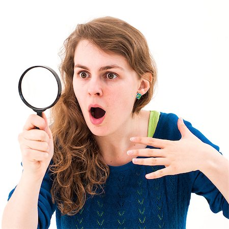 simsearch:400-04554899,k - young woman through a magnifying glass with a surprised expression Stock Photo - Budget Royalty-Free & Subscription, Code: 400-07174630