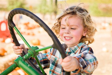 ranchers - Adorable Young Boy Playing on an Old Tractor in a Rustic Outdoor Fall Setting. Stock Photo - Budget Royalty-Free & Subscription, Code: 400-07174834