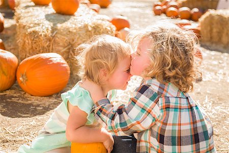 simsearch:400-07179959,k - Sweet Little Boy Kisses His Baby Sister in a Rustic Ranch Setting at the Pumpkin Patch. Stockbilder - Microstock & Abonnement, Bildnummer: 400-07174833