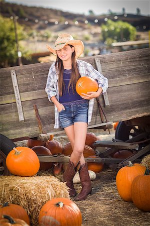 simsearch:400-07179959,k - Preteen Girl Wearing Cowboy Hat Portrait at the Pumpkin Patch in a Rustic Setting. Stockbilder - Microstock & Abonnement, Bildnummer: 400-07174859