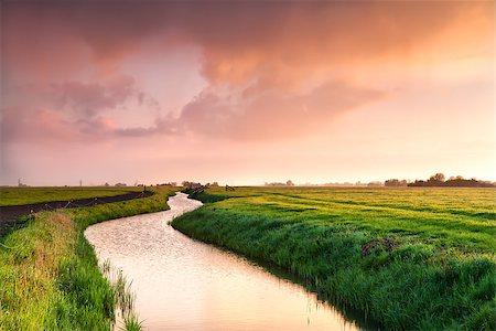 dramatic sunrise over canal in Dutch farmland, Groningen Stock Photo - Budget Royalty-Free & Subscription, Code: 400-07174947