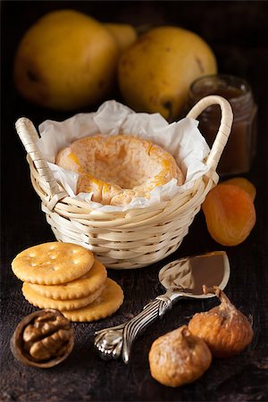 simsearch:400-05682309,k - French cheese Lagres in a basket with dried fruits, nuts, crackers and confiture on a dark wooden background. Stock Photo - Budget Royalty-Free & Subscription, Code: 400-07175510