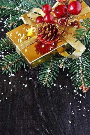 Christmas composition with golden christmas gift and spruce branch. Stock Photo - Budget Royalty-Free & Subscription, Code: 400-07175520