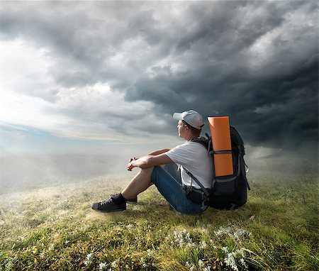 Tourist resting on the hill under storm clouds Stock Photo - Budget Royalty-Free & Subscription, Code: 400-07175748