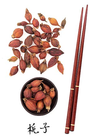simsearch:400-07174356,k - Gardenia fruit used in traditionl chinese herbal medicine with mandarin title script translation and chopsticks. Zhi zi. Stock Photo - Budget Royalty-Free & Subscription, Code: 400-07175925