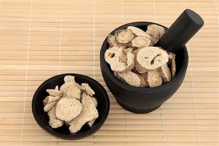 simsearch:400-07174356,k - Atractylodes herb used in chinese herbal medicine in a mortar with pestle and bowl over bamboo.  Bai  zhu. Stock Photo - Budget Royalty-Free & Subscription, Code: 400-07175940