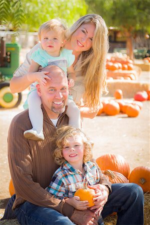 simsearch:400-07179959,k - Attractive Family Portrait in a Rustic Ranch Setting at the Pumpkin Patch. Stockbilder - Microstock & Abonnement, Bildnummer: 400-07176166