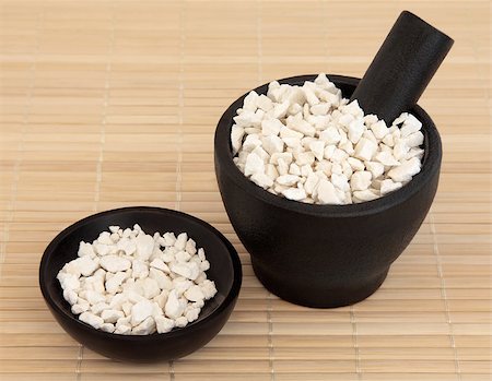 simsearch:400-06521200,k - Poria cocus used in chinese herbal medicine in a black stone mortar with pestle and bowl over bamboo. Fu ling. Wolfiporia extensa. Stockbilder - Microstock & Abonnement, Bildnummer: 400-07176433