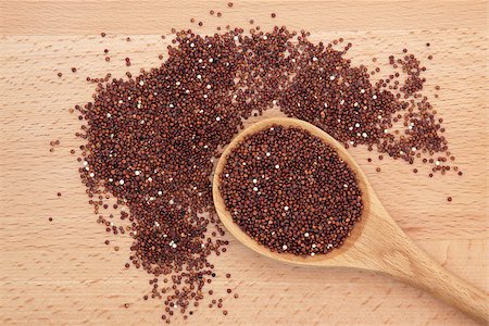 simsearch:400-07993665,k - Organic quinoa grain in a wooden spoon over beech wood board. Fotografie stock - Microstock e Abbonamento, Codice: 400-07176441