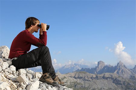 simsearch:400-07176526,k - Young man looking through binoculars in the mountains Stock Photo - Budget Royalty-Free & Subscription, Code: 400-07176524