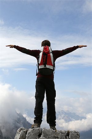 A young climber on a mountain top stretching his arms like flying Stock Photo - Budget Royalty-Free & Subscription, Code: 400-07176538