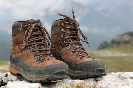 Hiking shoes of a hiker on a rock in the mountains Stockbilder - Microstock & Abonnement, Bildnummer: 400-07176532