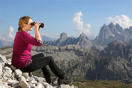 simsearch:400-07176526,k - Young woman looking through binoculars in the mountains Stock Photo - Budget Royalty-Free & Subscription, Code: 400-07176542