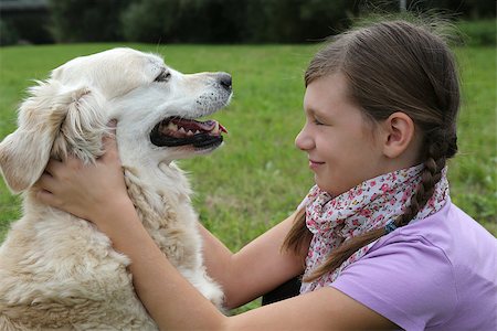 simsearch:400-05352235,k - Little girl caressing a dog on a meadow Photographie de stock - Aubaine LD & Abonnement, Code: 400-07176555