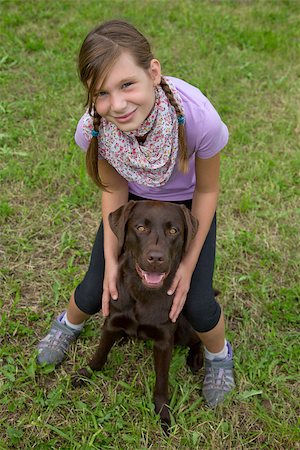 simsearch:400-05352235,k - Little girl embracing her dog friend on a meadow Photographie de stock - Aubaine LD & Abonnement, Code: 400-07176561