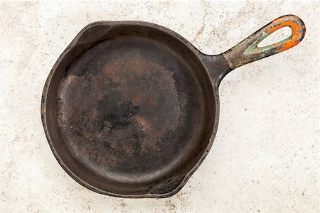 simsearch:400-07620929,k - a small grunge, iron frying pan on a ceramic itle Stock Photo - Budget Royalty-Free & Subscription, Code: 400-07176618