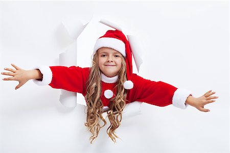 Happy santa girl opening the holidays season - leaning through hole in paper layer Photographie de stock - Aubaine LD & Abonnement, Code: 400-07176677