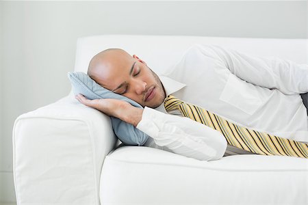 Elegant young businessman sleeping on sofa at home Photographie de stock - Aubaine LD & Abonnement, Code: 400-07177547