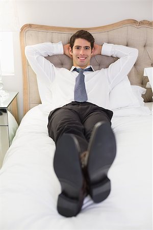 sophisticated home smile - Portrait of a relaxed smiling well dressed man lying in bed at home Stock Photo - Budget Royalty-Free & Subscription, Code: 400-07177913