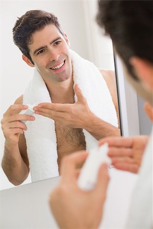Close up of young man with reflection putting moisturizer on his face Stock Photo - Budget Royalty-Free & Subscription, Code: 400-07177995