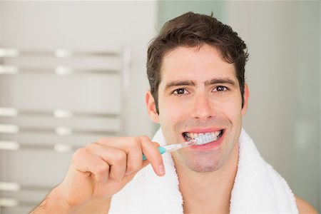 Close up portrait of a young man brushing teeth in the bathroom Stock Photo - Budget Royalty-Free & Subscription, Code: 400-07178008