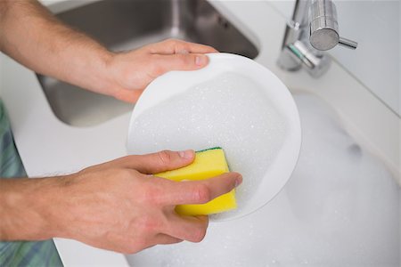 Close up of a man's hands doing the dishes at kitchen sink in the house Stock Photo - Budget Royalty-Free & Subscription, Code: 400-07178101