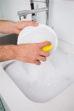 Close up of a man's hands doing the dishes at kitchen sink in the house Stock Photo - Budget Royalty-Free & Subscription, Code: 400-07178102