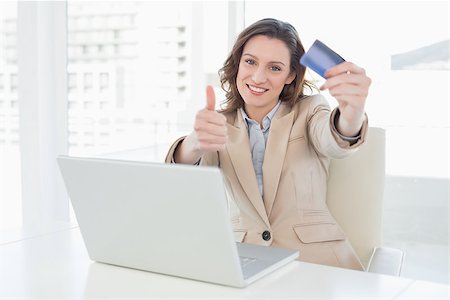 simsearch:400-07333971,k - Businesswoman doing online shopping through laptop and credit card in office Stock Photo - Budget Royalty-Free & Subscription, Code: 400-07178836