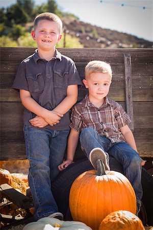 simsearch:400-07173780,k - Two Young Boys at the Pumpkin Patch Leaning Against Antique Wood Wagon. Stockbilder - Microstock & Abonnement, Bildnummer: 400-07179038